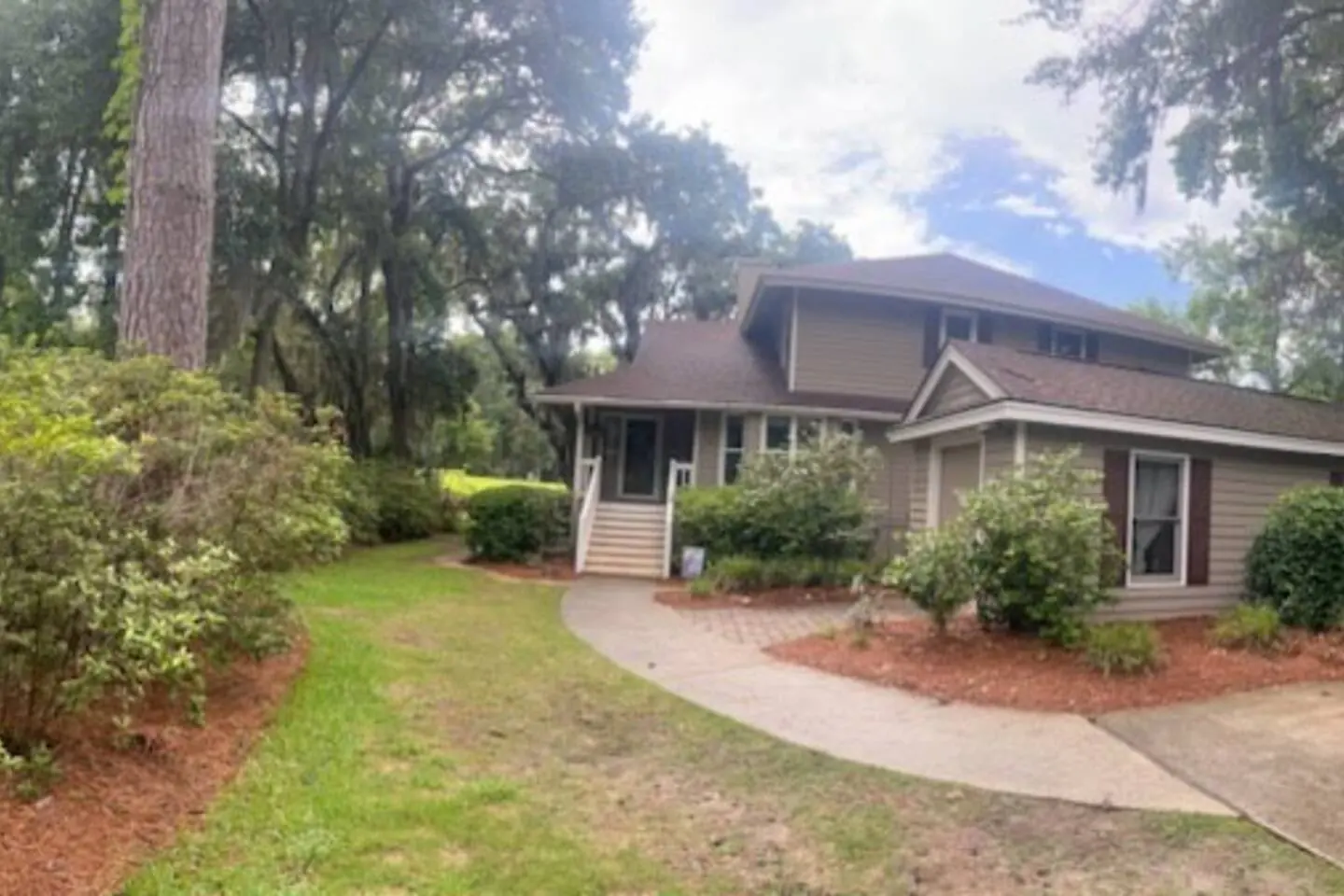 Front of the townhouse beneath the oaks